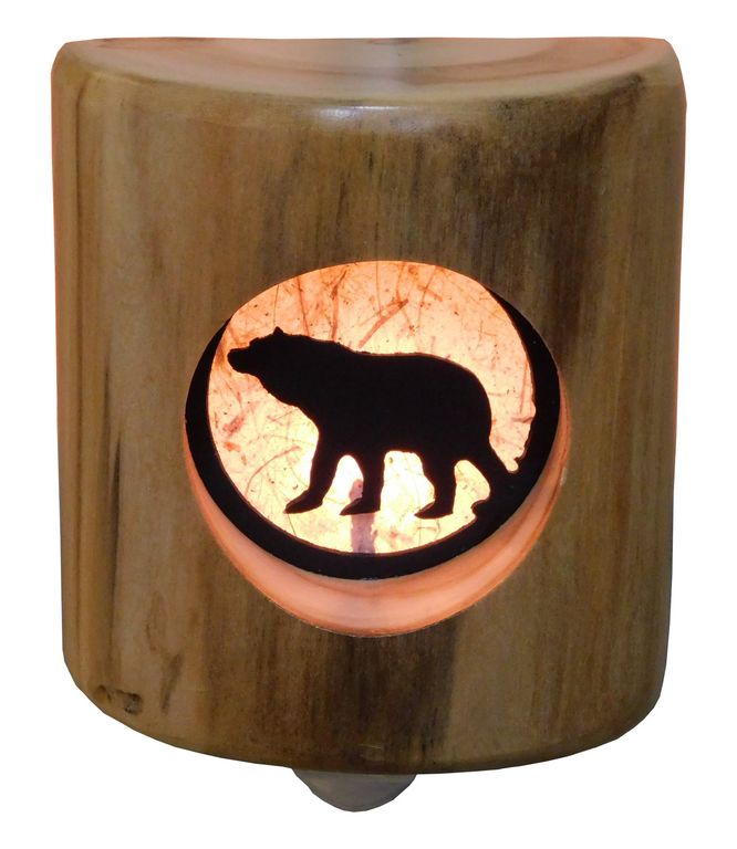 A wooden log night light with an silhouette of a bear cut into the wood, illuminated from within.
