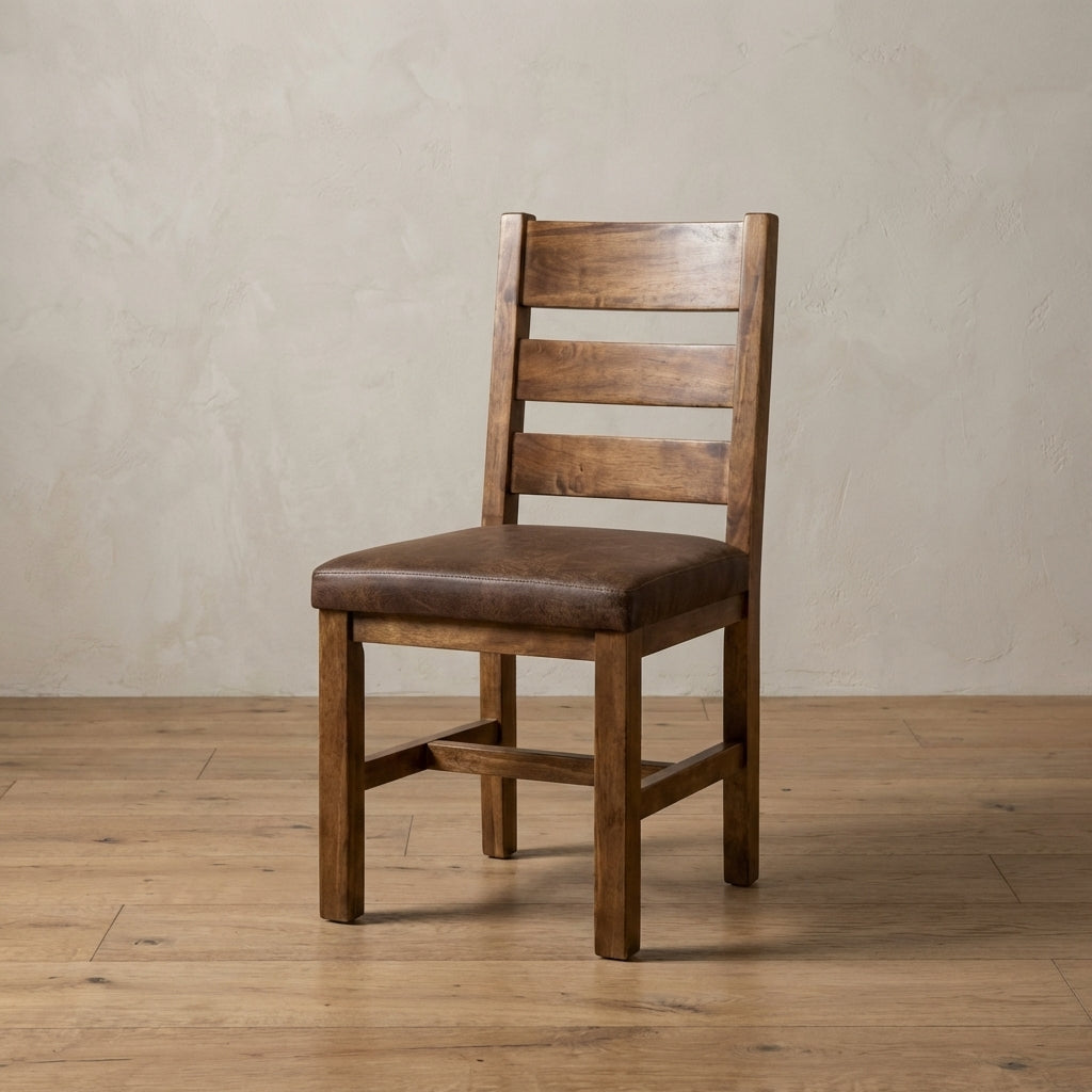 Farmhouse aspen frisco chair with a brown cushioned seat on a wooden floor against a beige wall.